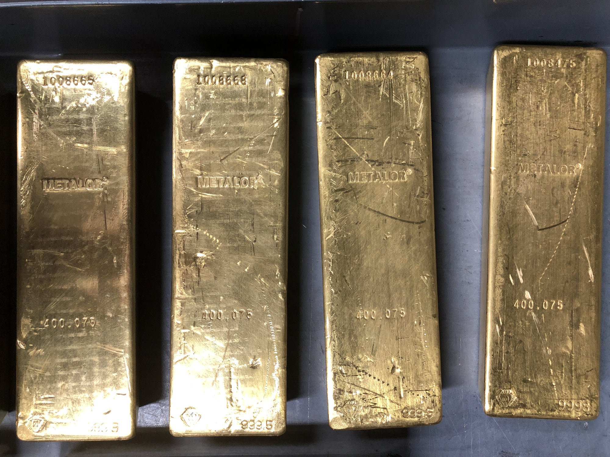 4 Metalor gold bars on a tray within a vault