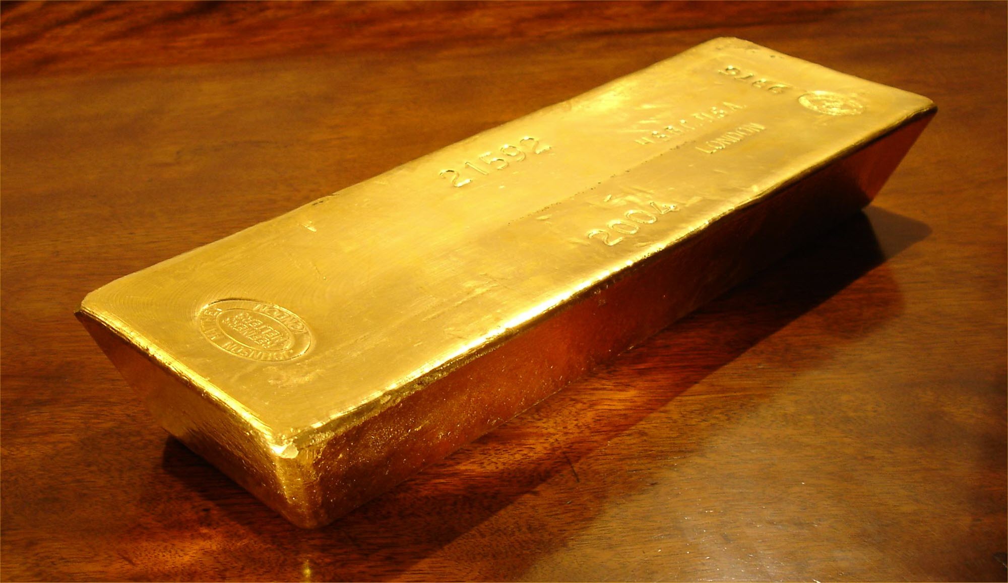 Gold bar on polished wooden table